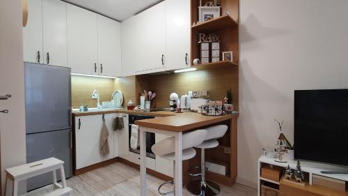 a small kitchen with a table and a counter at Borovets Cozy Mountain Apartments in Borovets