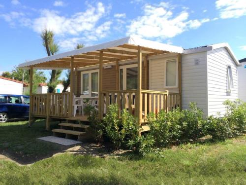 a small house with awning and a porch at Club del Sole Vigna sul Mar Family Collection in Lido di Pomposa