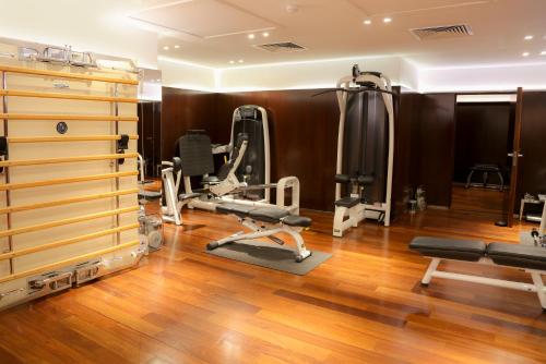 a gym with treadmills and machines in a room at Hôtel Le Royal Monceau Raffles Paris in Paris