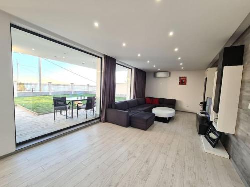 a living room with a couch and a table at Villa ARUBA in Balchik