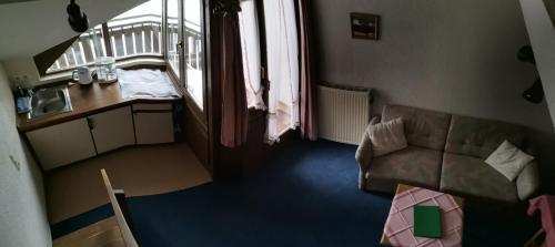 a living room with a couch and a table at Aparthotel Kupferkanne in Todtmoos