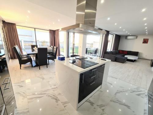 a kitchen and living room with a counter top at Villa ARUBA in Balchik