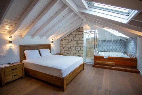 a bedroom with a bed and a bath tub at Kokopelli Alacati in Alaçatı