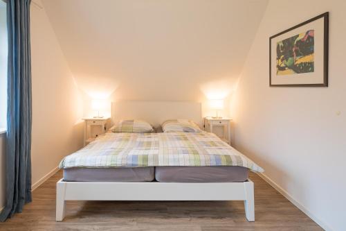 Säng eller sängar i ett rum på Ferienhaus In de Bargen