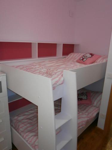 a white bunk bed in a small room at JUNTO AL PILAR in Zaragoza