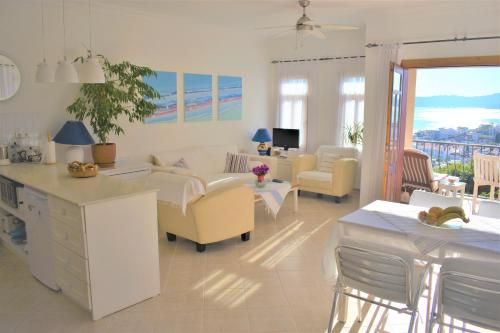 a living room with a couch and chairs and a table at Manzara Apartment in Kas
