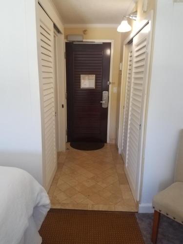 a hallway with a black door in a room at 2417 at Oceanfront Resort Lihue Kauai Beach Drive Private Condo in Lihue