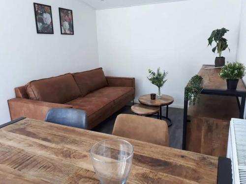 a living room with a couch and a table at de4SeiZoentjes in Schoonebeek