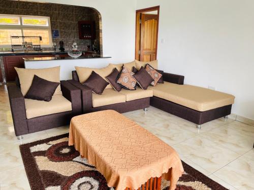 a living room with a couch and a table at Ocean Blue Bay in Anse Volbert Village