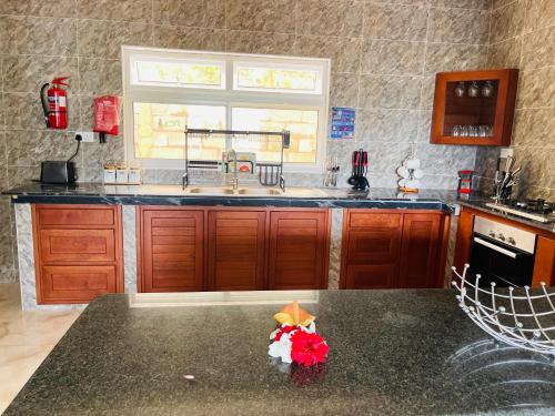 a kitchen with a sink and a counter top at Ocean Blue Bay in Anse Volbert Village
