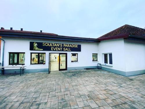 a large white building with a sign that reads suniths paradise event stall at Landhotel zum kühlengrund & soultans paradise in Brensbach