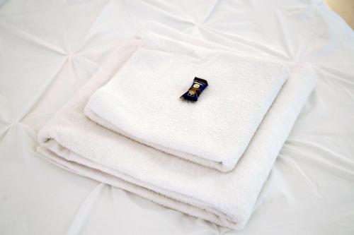a close up of three towels on a bed at Apartamentos DC in Benalmádena