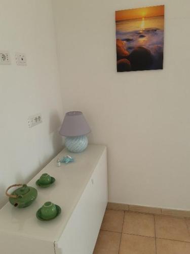 a white table with a lamp on top of it at Fronte Mare in Avola