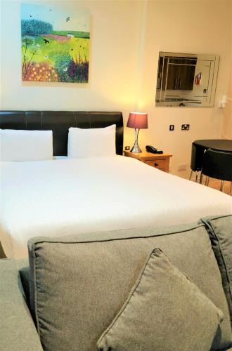 a bedroom with a large white bed in a room at Grand Plaza Serviced Apartments in London