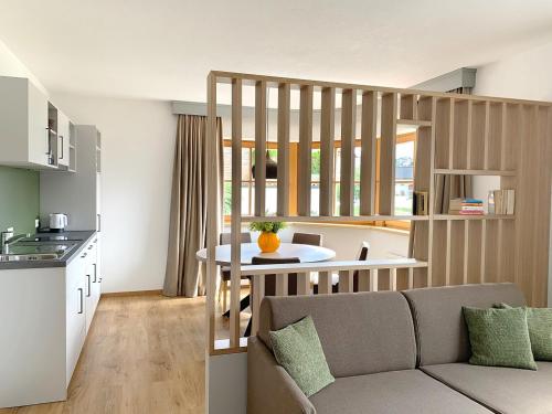 a kitchen and living room with a couch and a table at Nagalu in Fiss