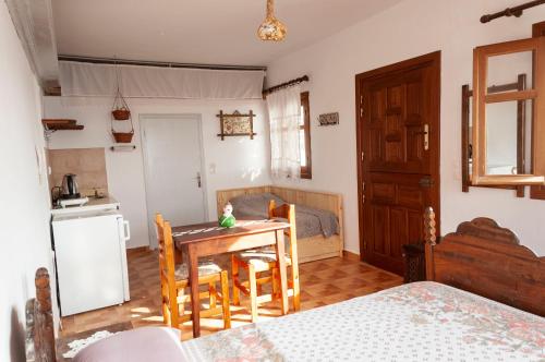 a kitchen and dining room with a table and chairs at Palmhouses in Afiartis