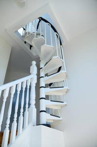a white spiral staircase in a house at Stable View, Clara Meadows Dunfanghy in Dunfanaghy
