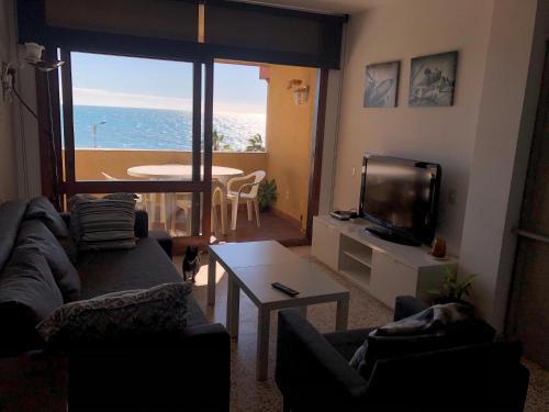 a living room with a view of the ocean at POLL ALL YEAR, PISCINA TODO EL AÑo in Torre de Benagalbón