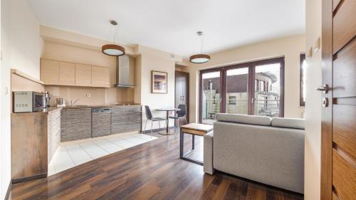 a kitchen and living room with a couch and a table at Foka, Sun & Snow in Hel