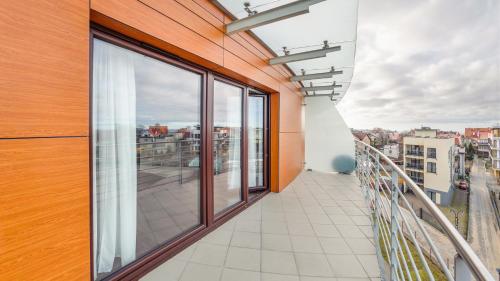 a balcony with a view of a city at Foka, Sun & Snow in Hel