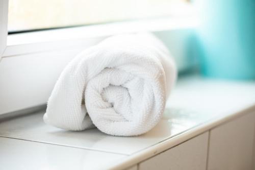 a white towel sitting on a counter in a bathroom at Hotel Am Sportpark in Duisburg