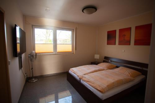 a bedroom with a bed and a window at Hotel Am Sportpark in Duisburg