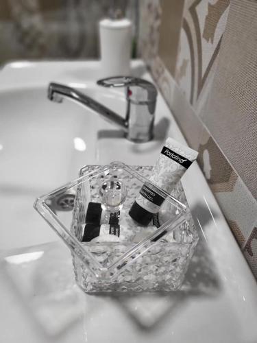 a bathroom sink with a bottle of toothpaste on it at Casa 115 Toplița in Topliţa