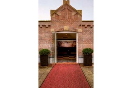 a red carpet entrance to a building with a red carpet at Hotel Van Gogh in Amsterdam