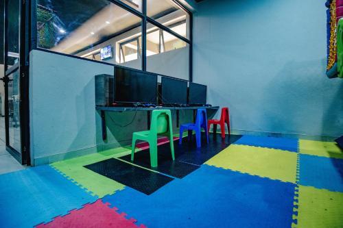 a room with a table and chairs on a colorful floor at Urban Bliss Hotel in Kabwe