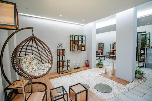 a living room with a swing in a room at Urban Bliss Hotel in Kabwe