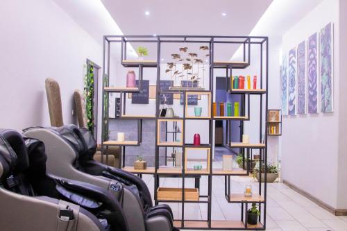 a room with a shelf with various items on it at Urban Bliss Hotel in Kabwe