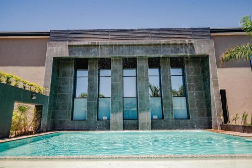a large swimming pool in front of a building at Urban Bliss Hotel in Kabwe