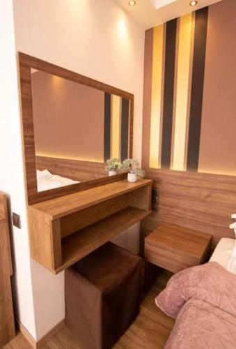 a mirror on the wall of a bedroom at Mont Helmos Hotel in Klitoria