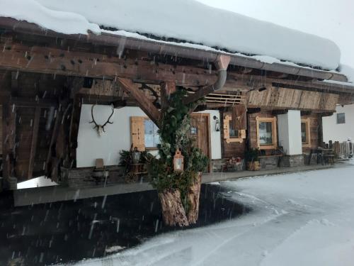 a building with snow on top of it at Haus Wildschütz in Hippach