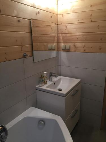 a small bathroom with a sink and a toilet at Dom z bala Dar Lasu in Szczytno