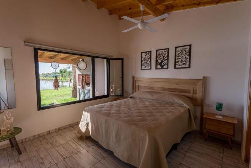 a bedroom with a large bed and a window at La Matera Apart in Costa del Este