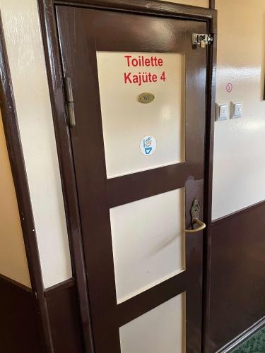 a door with a sign that reads toilet karate at Schiffspension Luise in Potsdam