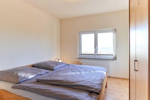 a bedroom with a bed and a window at Seestern in Nordstrand