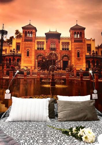 a bed in front of a large building at Hostal Paco´s in Seville