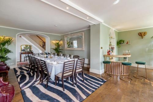 a dining room with a table and chairs at Historic country house retreat with hot tub, ideal for large groups in Petty France