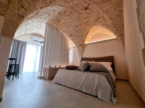 Postel nebo postele na pokoji v ubytování PIRANO Suite e Spa