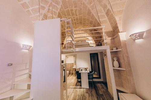 a room with a loft bed and a desk at Le Suite Bed in Pulsano