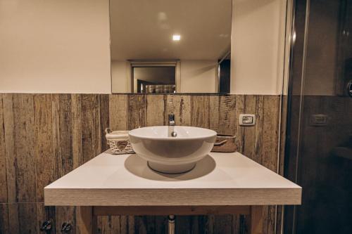 a bathroom with a bowl sink on a counter at Le Suite Bed in Pulsano
