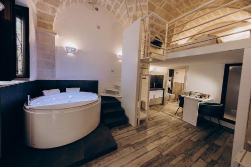 a bathroom with a tub in the middle of a room at Le Suite Bed in Pulsano