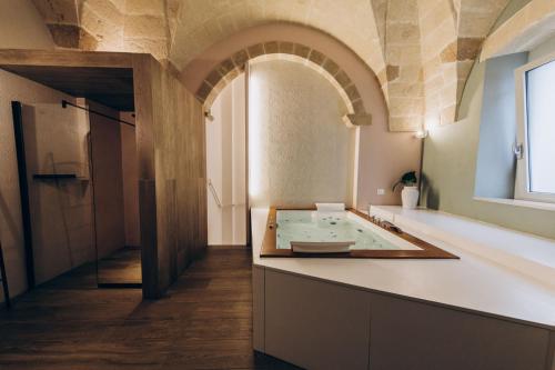 a large bathroom with a large bath tub in a room at Liconti Exclusive Rooms in Pulsano