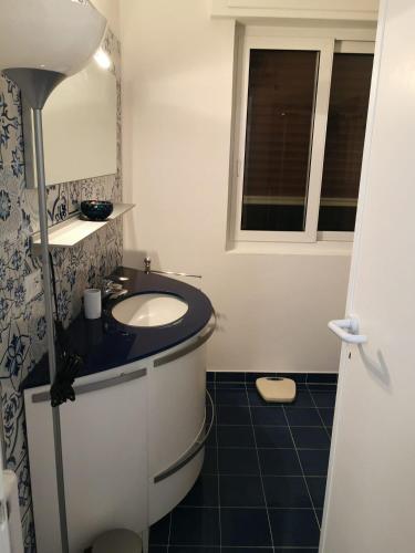 a bathroom with a sink and a mirror at B&B Sanremo dely' house in Sanremo