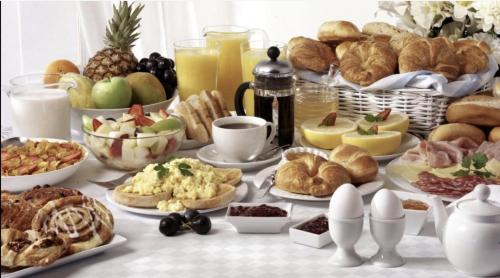 a table topped with lots of different types of breakfast foods at Upstairs Boutique in Bucharest