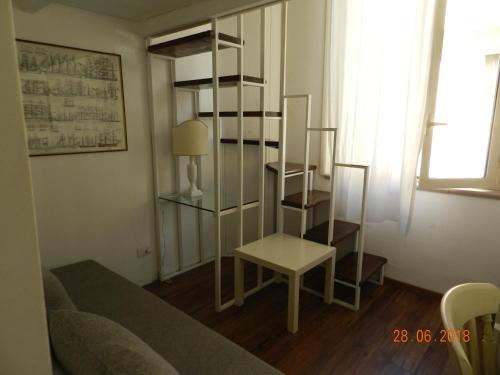 sala de estar con sofá y estante para libros en Casa di Anna - monolocale centrale en Reggio Calabria