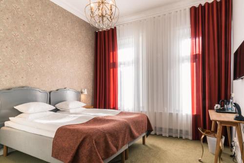 En eller flere senge i et værelse på Hotel Lorensberg