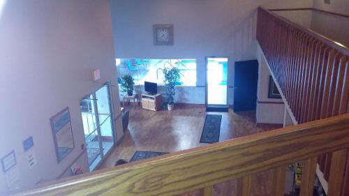 an overhead view of a living room with a staircase at Northwoods Best Inn - Chetek in Chetek